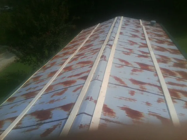 Rusted metal roof panels with new wood purlins before replacement — Storm Damage Roof Repair in Elmer by Roofing Brothers